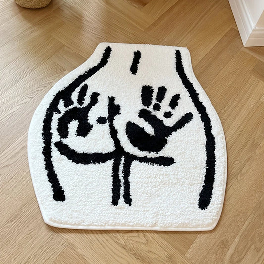 Tufted black and white floor rug featuring a bum with hand prints on