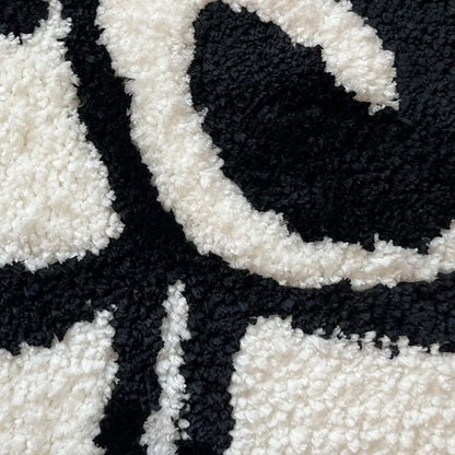 Close up of rug showing soft black and white tufted piles