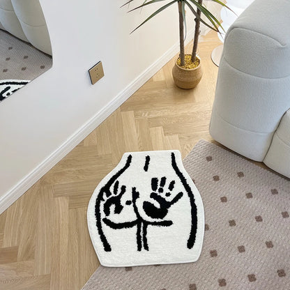 Tufted black and white floor rug featuring a bum with hand prints on