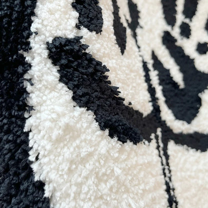 Close up of rug showing soft black and white tufted piles