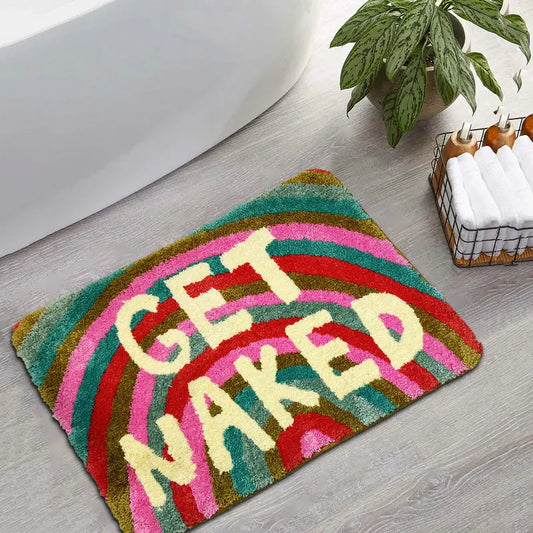 Rainbow coloured bath mat with text reading "Get Naked"